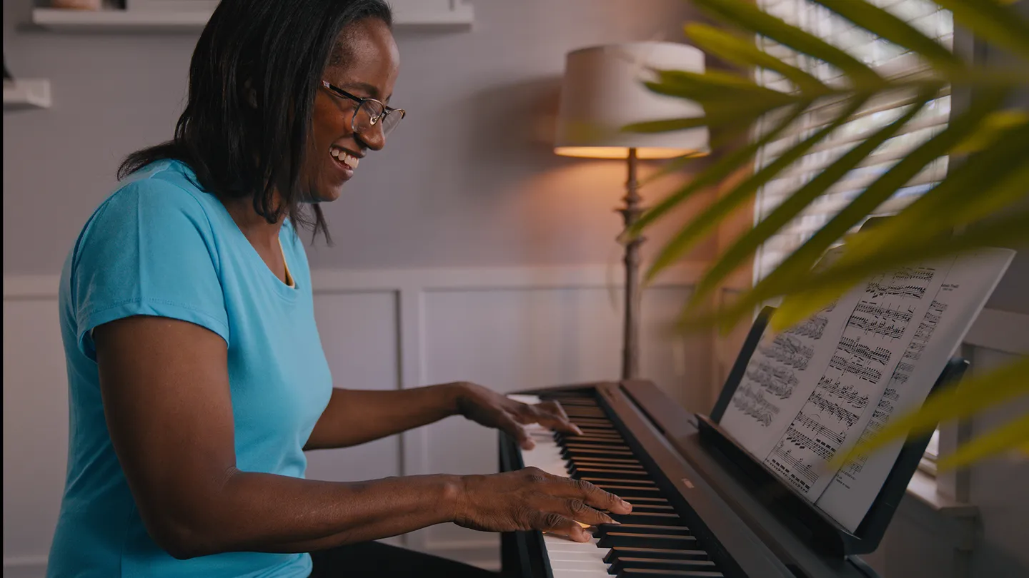 Woman playing a piano in her home